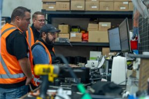 Three men using JET Charge Illuminate to asses assets