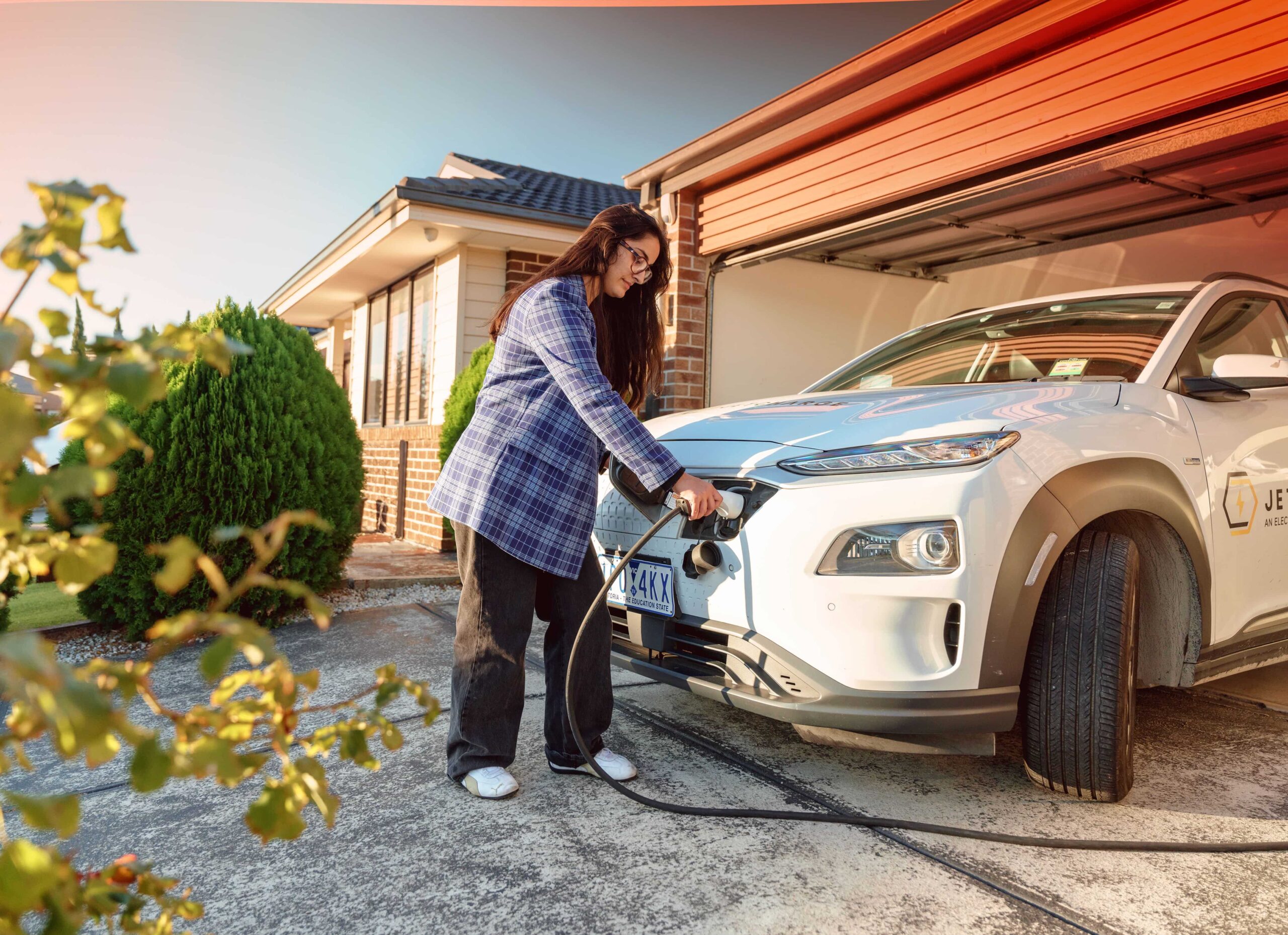 women charging EV at her home