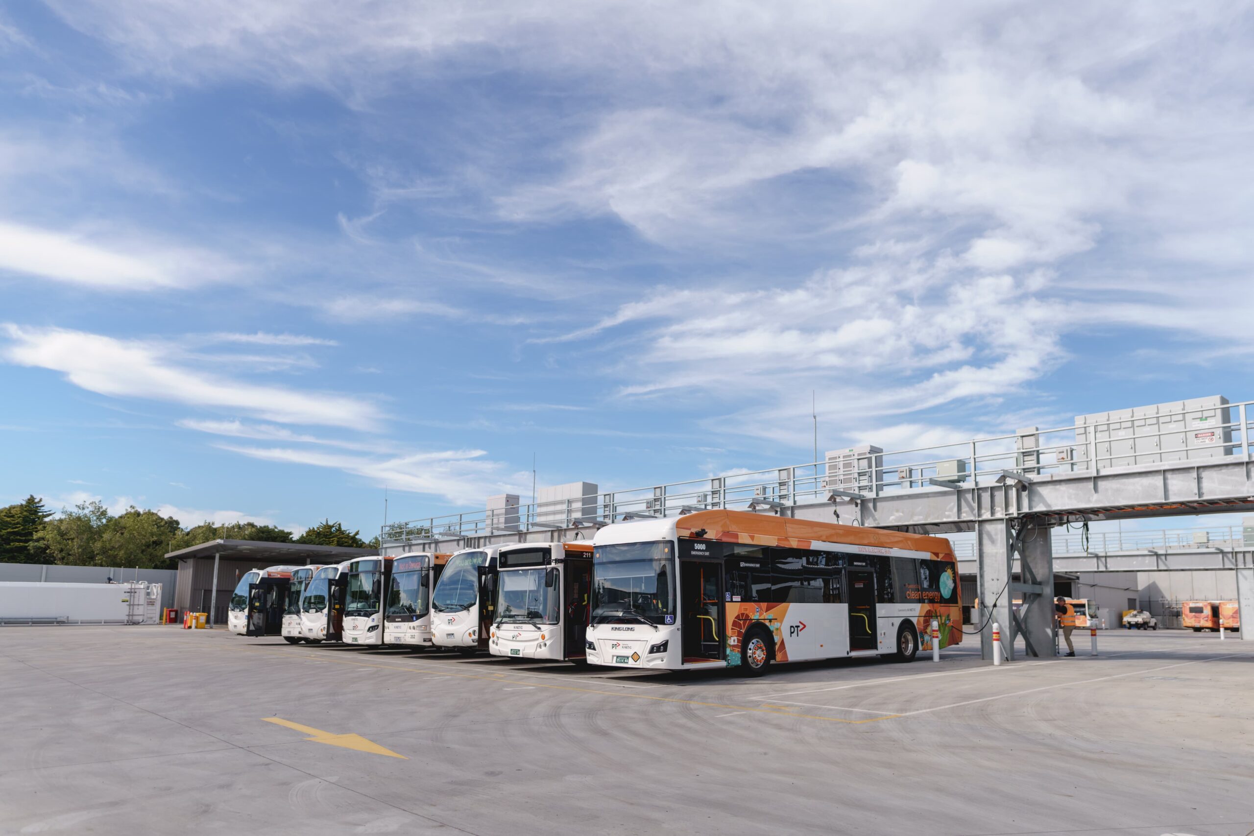 electric buses under charging gantry